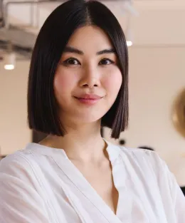 Mulher de negócios asiática sorrindo para a câmera.