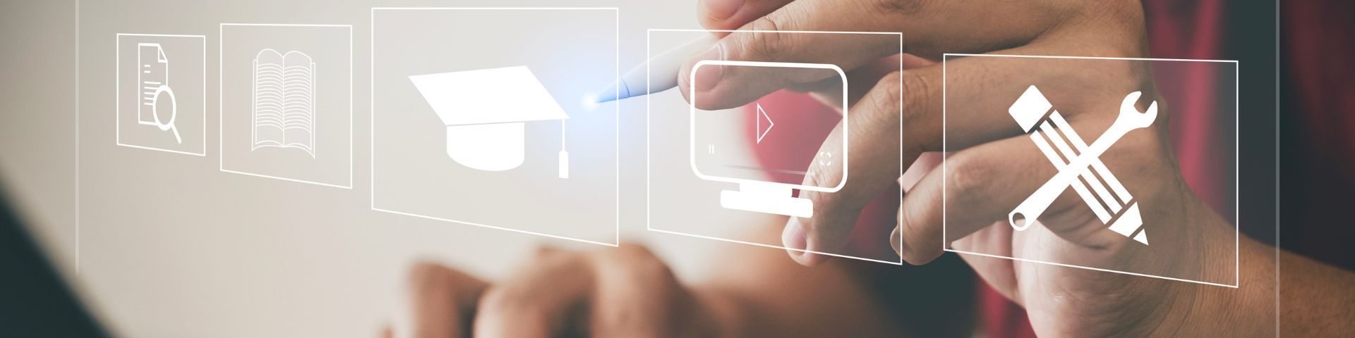 Mão segura uma caneta digital e toca ícones transparentes de educação, como livro aberto, chapéu de formatura e ferramentas de estudo, representando recursos de um curso livre online.